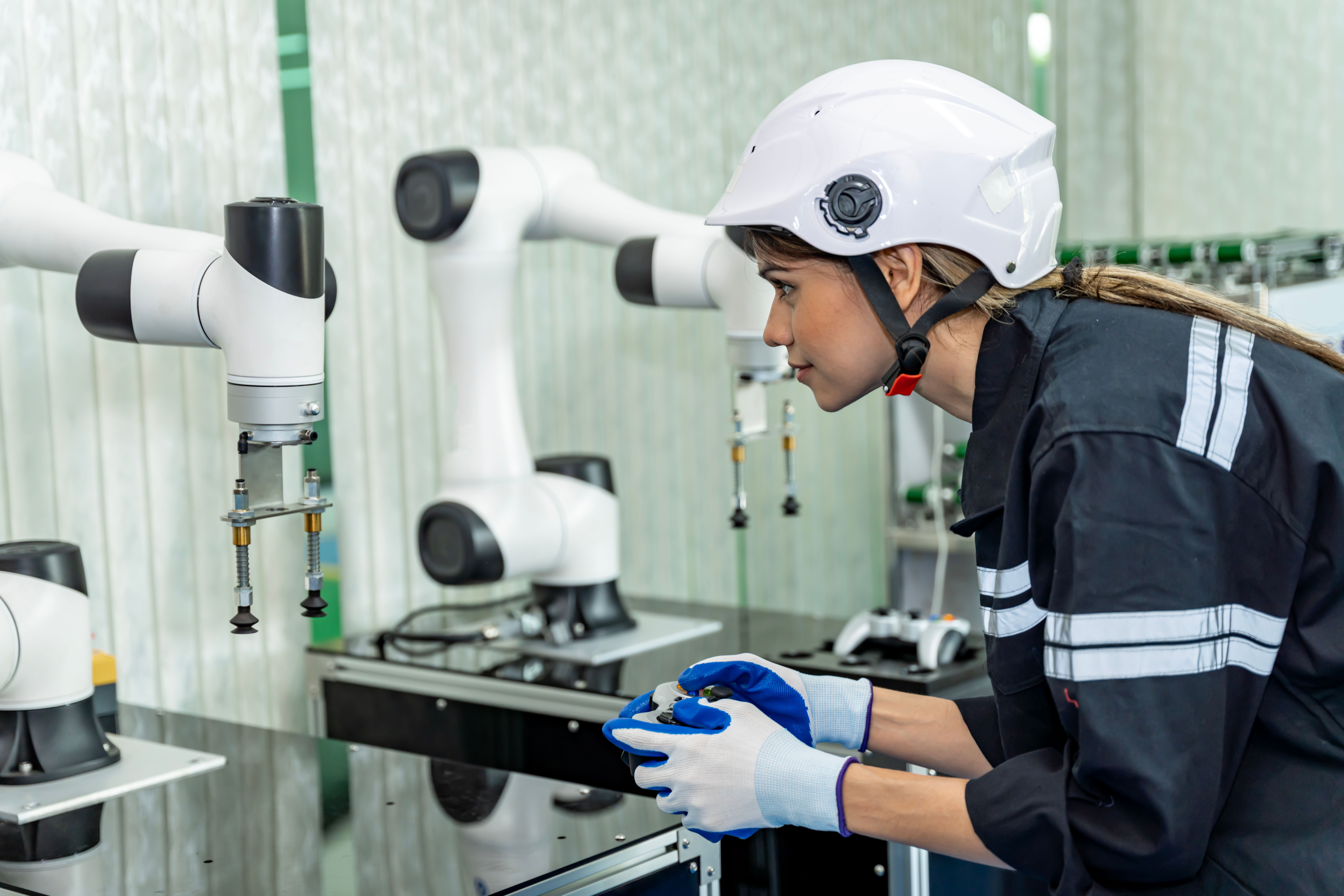 engineer_works_with_robotic_arm