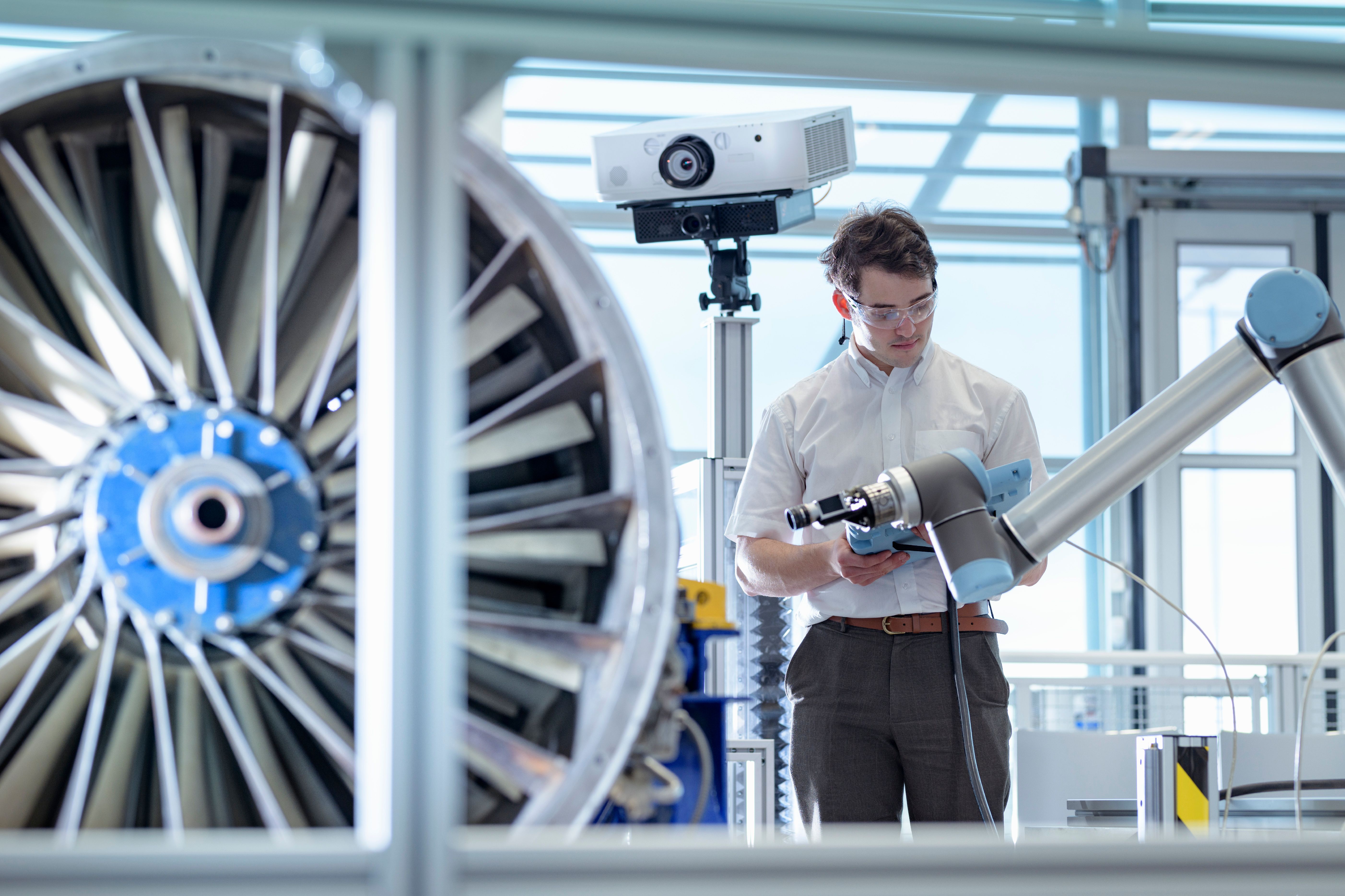 engineer_works_with_robotic_arm